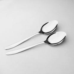 Two silver spoons on a light gray background